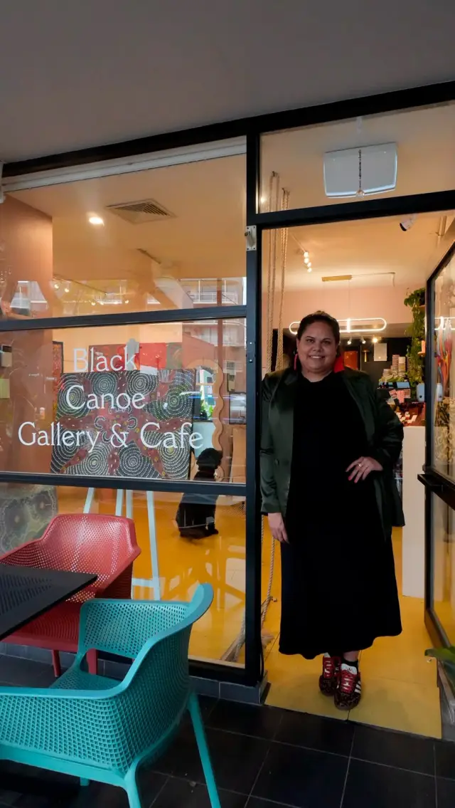 The Black Canoe founder Jodie Matthews at the door of the gallery and café on Botany Road