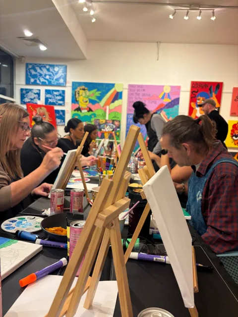 Guests painting at their easels during the Paint & Sip night