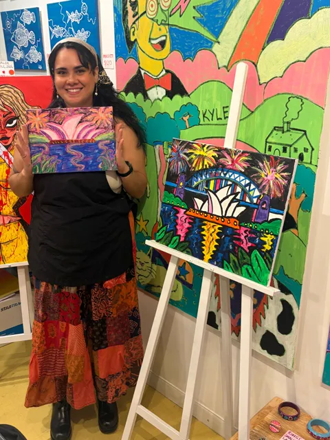 A guest with a pink and purple harbour painting