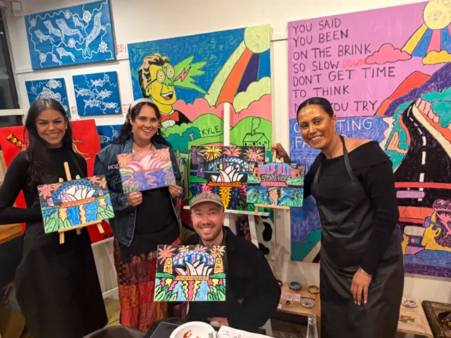 Guests and the artist celebrating their finished paintings